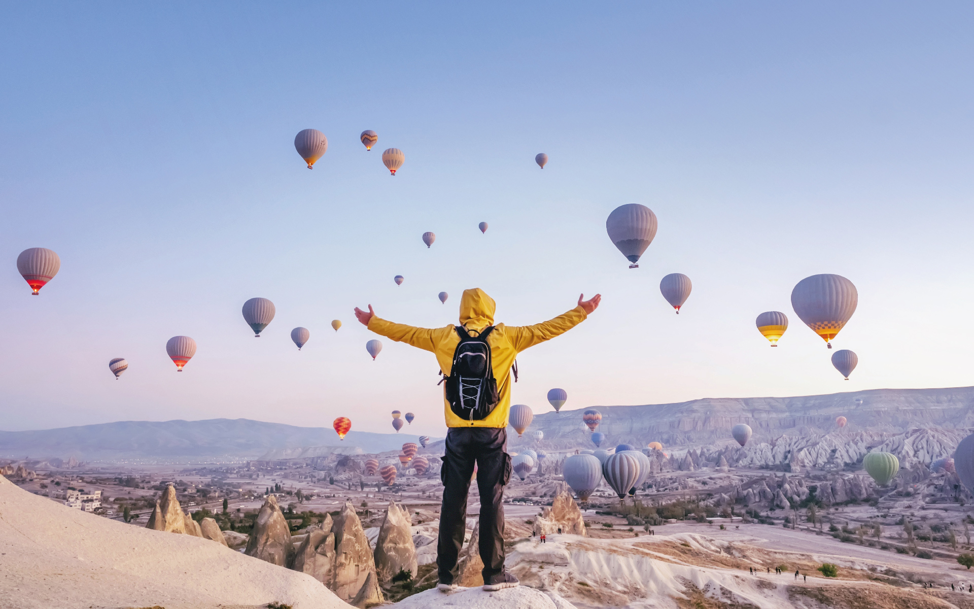 employee experience website Person with balloons in valley